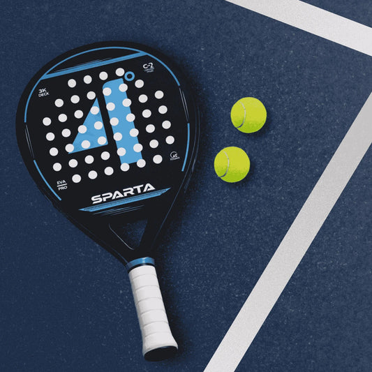 Sparta padel and two tennis balls on a blue surface with white lines