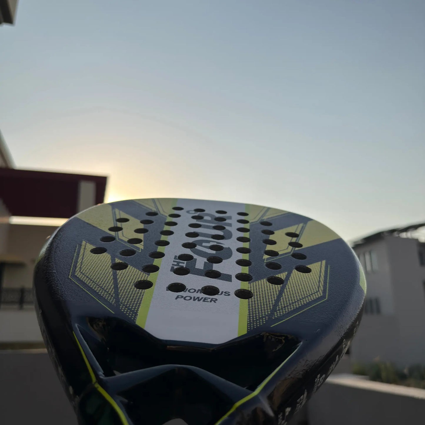 Close-up of a sports equipment with 'The Four Degree' branding against a blurred outdoor background.